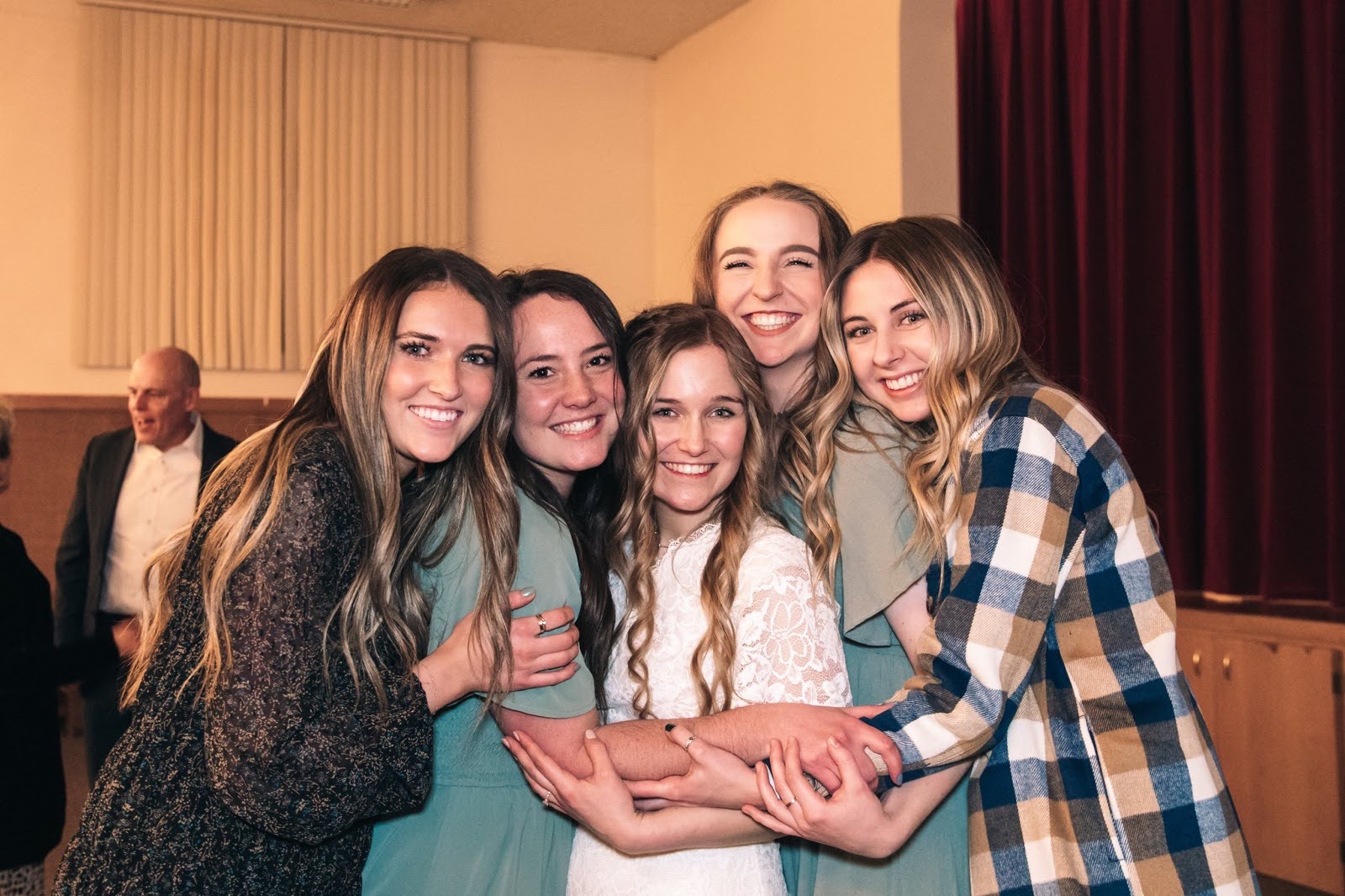 group of girls in dresses smiling together
